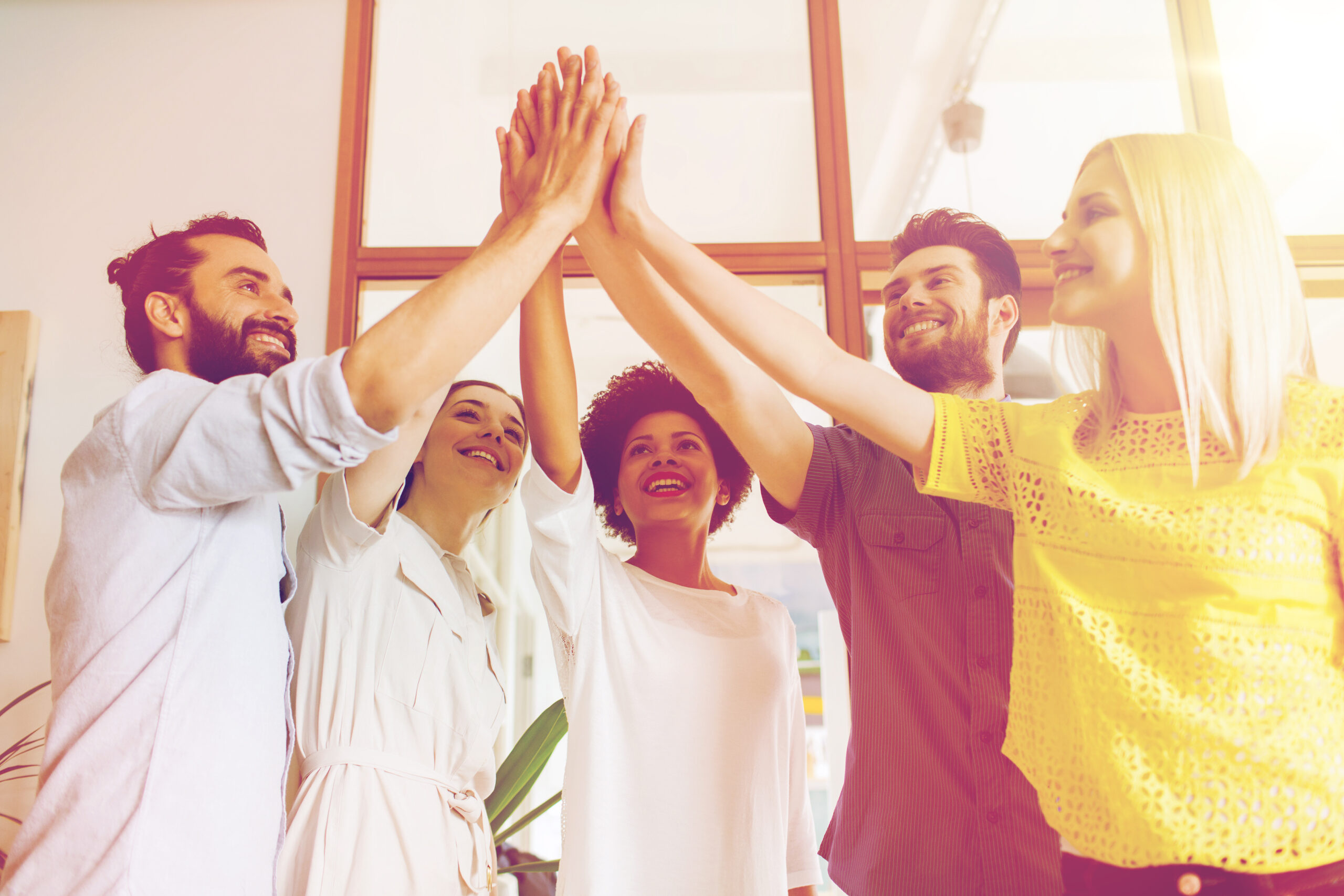 business, startup, gesture, people and teamwork concept - happy creative team making high five in office